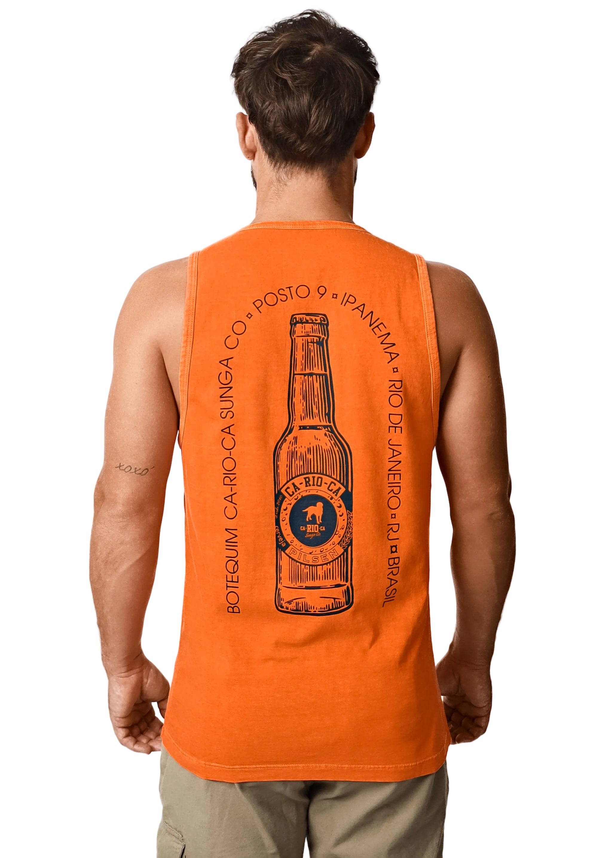 Man wearing an orange tank top with a bottle graphic and text on the back.