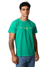 Man wearing a green t-shirt with text and graphics on a plain background