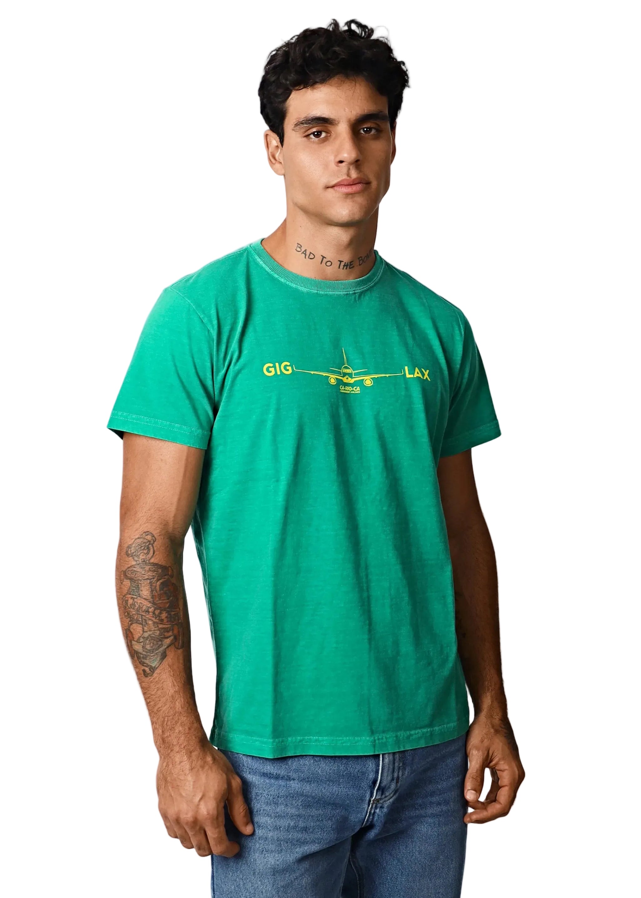 Man wearing a green t-shirt with text and graphics on a plain background