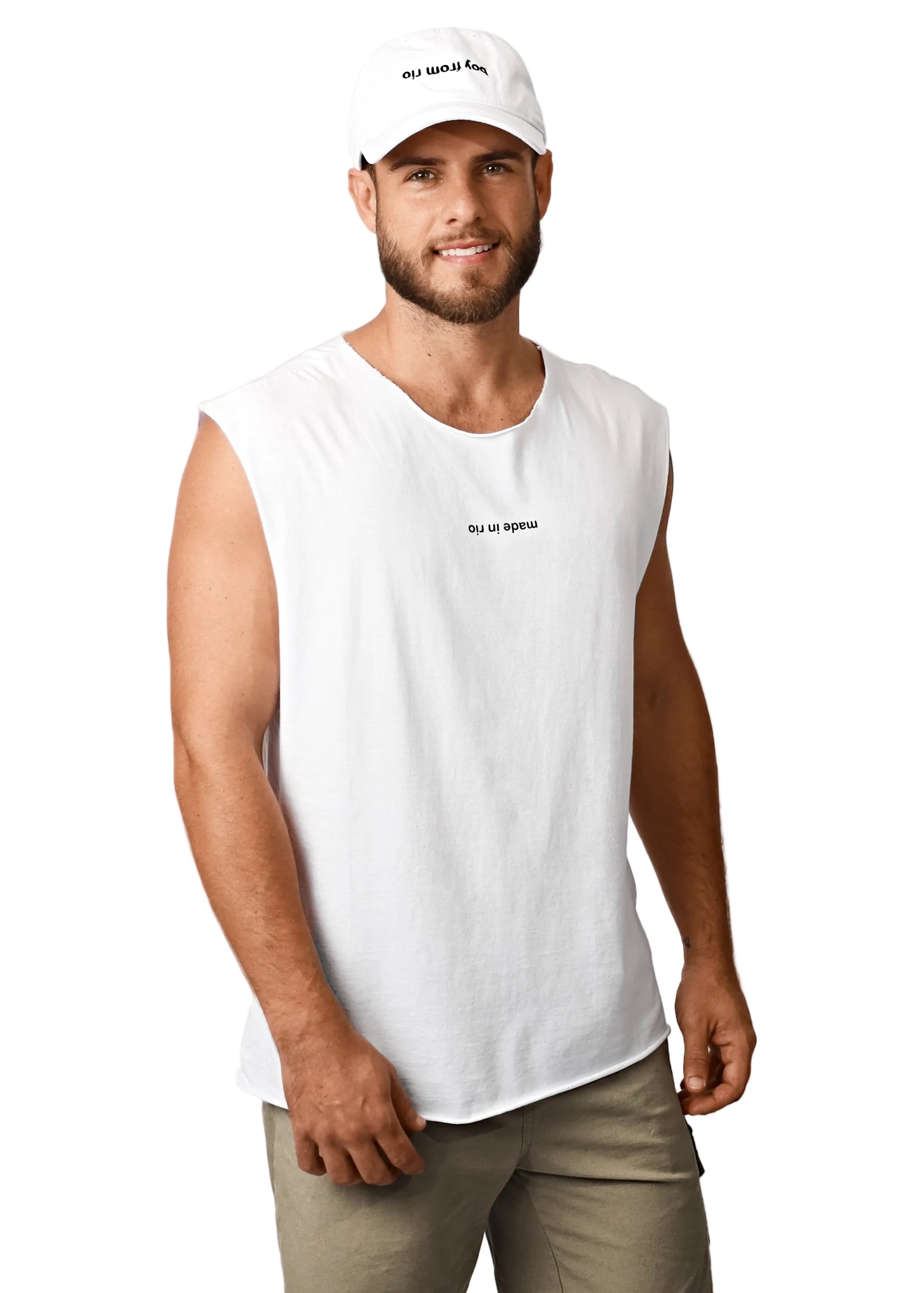Man wearing a white sleeveless shirt and cap on a plain background
