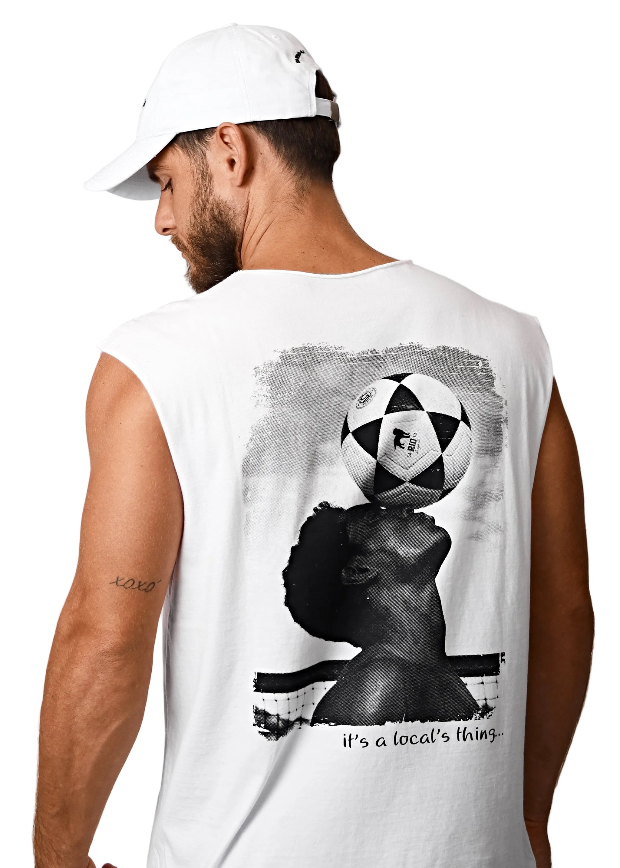Man wearing a white sleeveless shirt with a graphic design on the back, featuring a silhouette of a person with a soccer ball on their head.