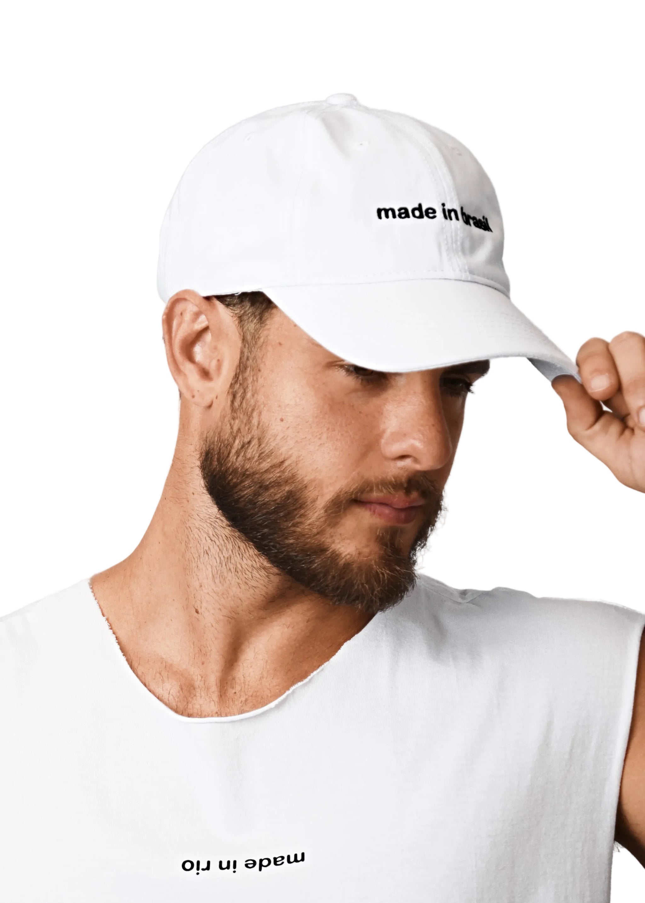 Man wearing a white cap with 'made in Rio' text on a light gray background