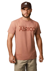 Man wearing a brown t-shirt with 'Praia do Abricó' text and a cap on a white background