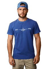 Man wearing a blue t-shirt with an airplane graphic and text, standing against a white background