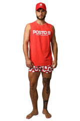 Man wearing a red 'Posto 9' tank top and patterned shorts on a white background